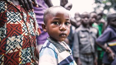 A young boy has his picture taken in Ivory Coast.