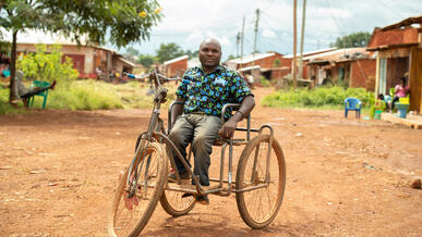 A man sits on a motorcycle in Tanzania.