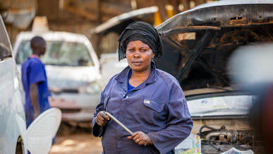 A female mechanic poses for a photo in Uganda.
