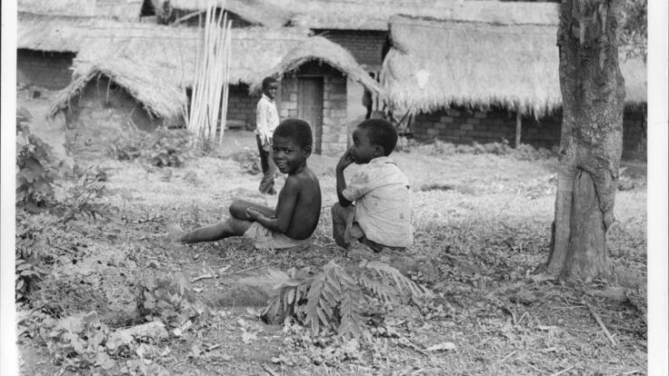 two little boys sitting on the ground