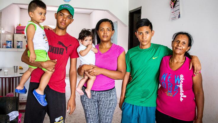 Cibel (centre) from Venezuela with his family in Colombia, where they received support from the IRC.