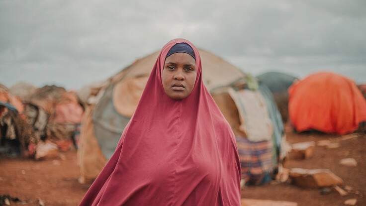 Amina standing facing camera at Torotorow IDP camp