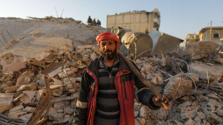 Mazin stands amongst rubble of the earthquake.