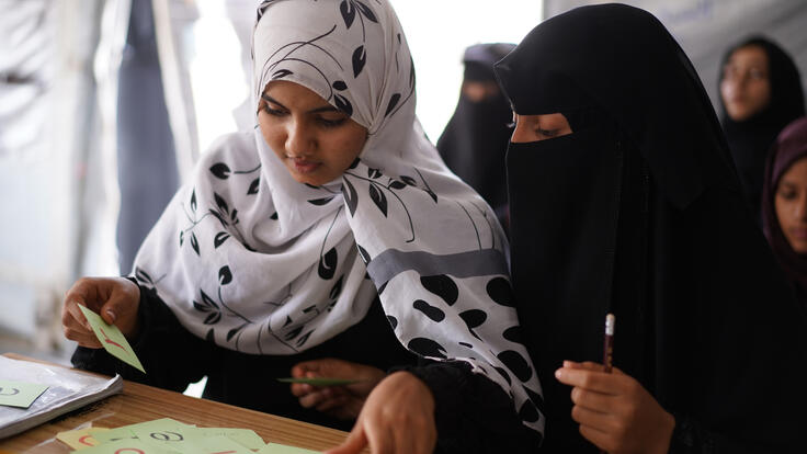 Maryam and Aisha, 14, in class at Akram Al-Sayadi school in Qatabah district. 