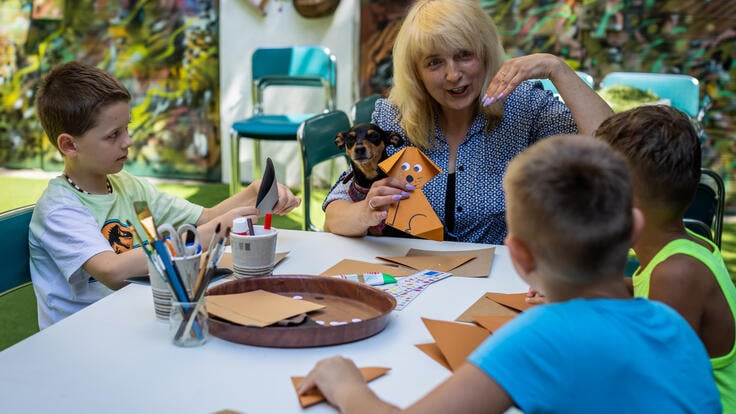 Oksana and David do an arts and crafts project alongside two other children in Poland.