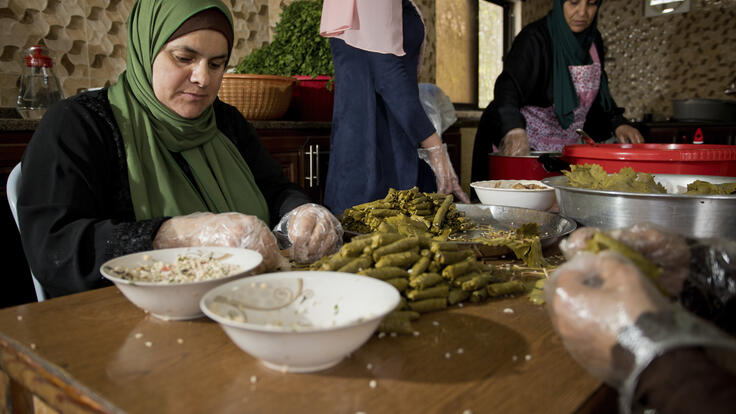 Basima, 44 years from Damascus rolling vine leaves at a Home Cooking Business in Jordan.