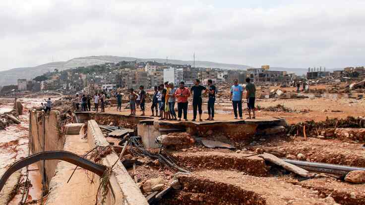 A group of Libyans looking at the flooding damage following Storm Daniel.