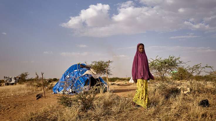 A young girl walks away from a temporary shelter in Mali. 