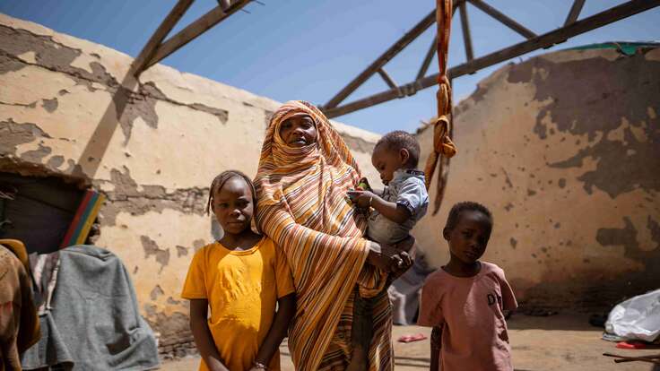 Altuma, 45, and her children stand inside their roofless shelter in Gedaref, Sudan.