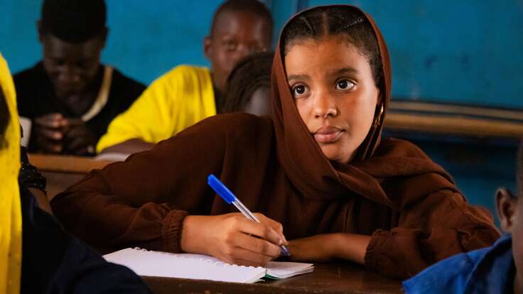 Gao, Mali. Samah, 15, looking at the blackboard while writing.