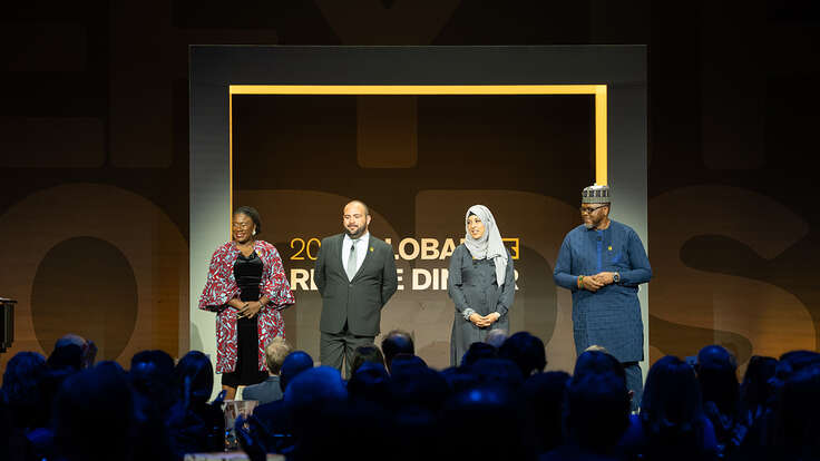 IRC staff stand together onstage at the IRC's Global Rescue Dinner.