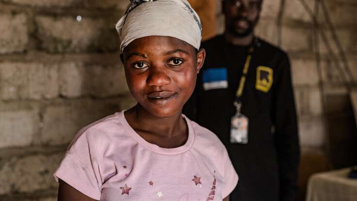 Gentille looks at the camera, smiling.  