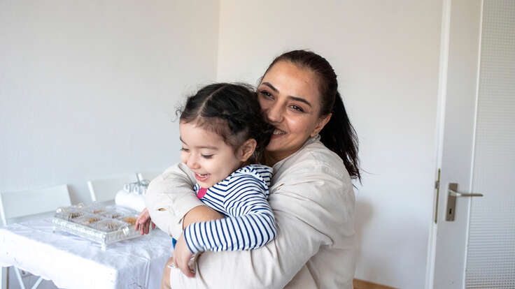 Bahar* is playing with her daughter Mina* in her new apartment in Berlin.