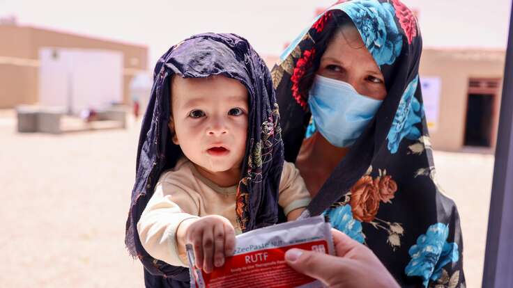 A packet of ready-to-use therapeutic food (RUTF) is given to Sahil and his mother Afsana at the IRC’s EU-supported health facility, during their follow up appointment.