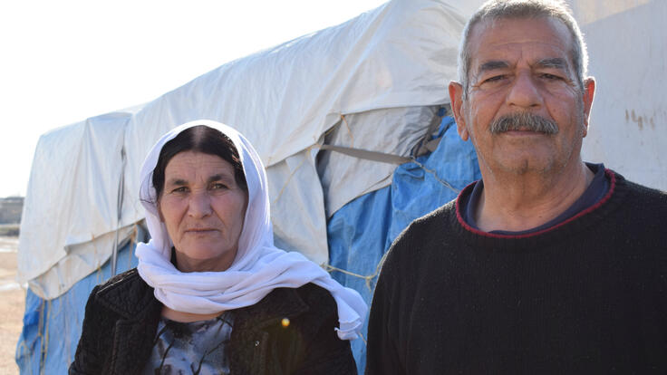Suleiman Khalf Kajo and his wife, Khabshe outside a tent in Newroz refugee camp in Syria