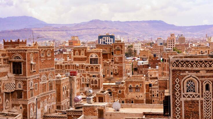 Tall ornate brick buildings create a beautiful city landscape.