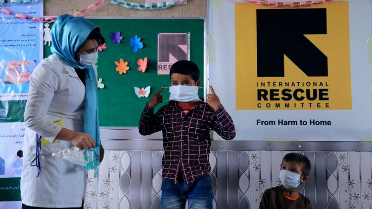 Boy putting on a surgical mask