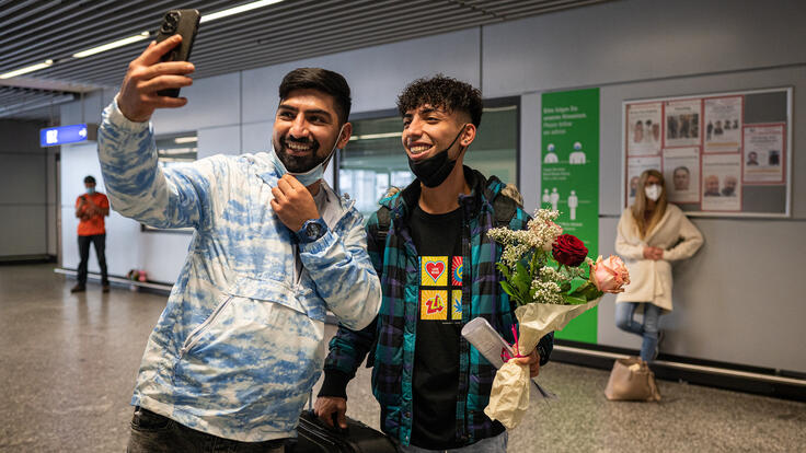 Brothers Ali and Mehdi take a selfie together at the airport.  