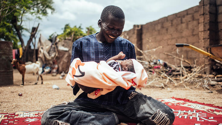 Ibrahim smiles at his baby, Bello Ibrahim a few hours after his child’s naming ceremony at his home in Gwoza, Borno, Nigeria. 