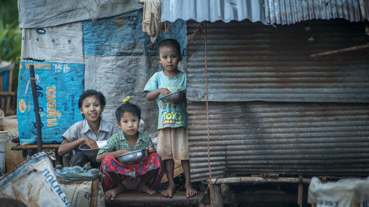 Children sit outside a makeshift shelter in a settlement for Burmese migrant workers near Mae Sot, Thailand.