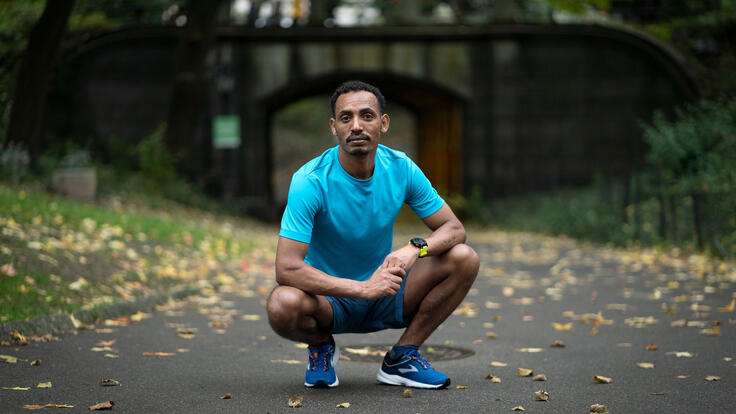 Tolassa stops for a rest after a training run in New York City's Central Park