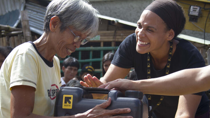 IRC staff and client interacting and smiling