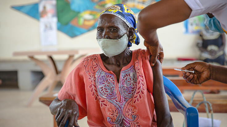 Enike Soduku receives the COVID-19 vaccine at Swiga health centre III in Bidi Bidi refugee settlement.