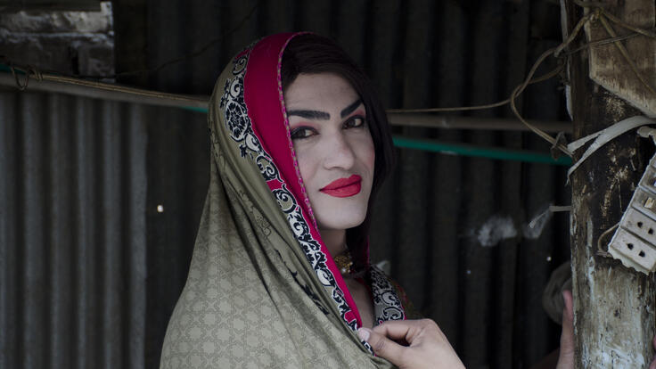 Namkeen, wearing a red, black and grey head scarf, poses for the camera 