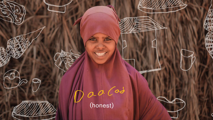 Asha Shoaib Hassan, wearing maroon, smiles. There is text on the page that reads "honest" in English and Somali. 