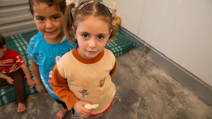 Two young Syrian girls inside a shelter in a refugee camp in Jordan. Photo: Meredith Hutchison