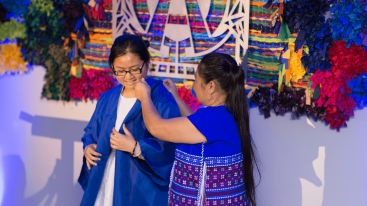 Eh Kaw Thaw is robed by her mother at the IRC Dallas Robing Ceremony