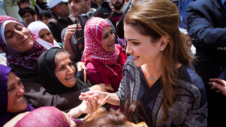 Queen Rania Al Abdullah of Jordan visiting the the Greek island and speaking to a large group of people.