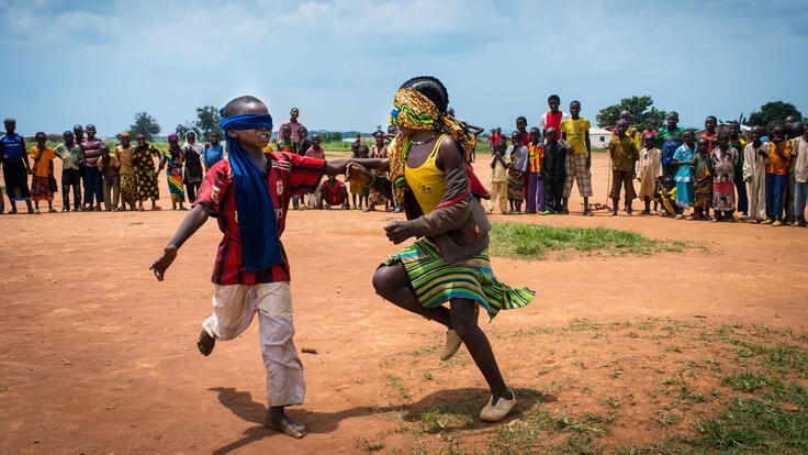 Children playing a blindfold game.