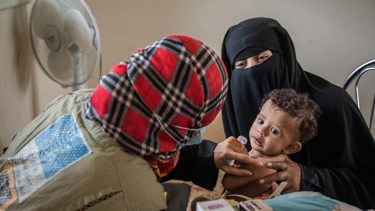 Mobile health team member providing a regular checkup to a child.