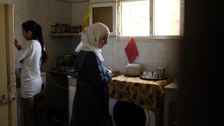 Amira cooking with her children.