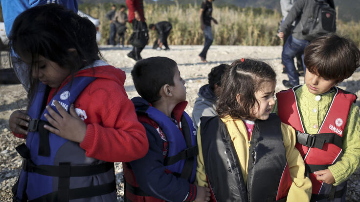 A group of kids wearing life jackets.