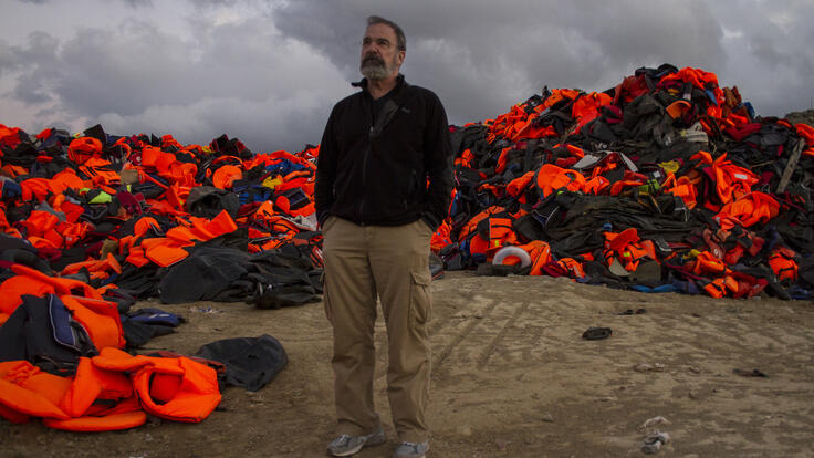 Mandy Patinkin standing in a sea of life jackets.