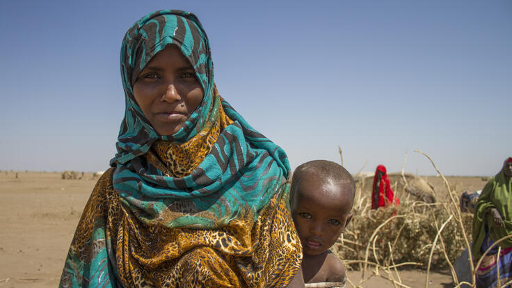 A mother holding her child.