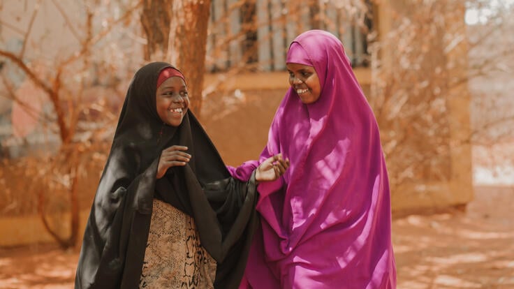 Zahara Adem and Shenkeron Abdi talking and laughing.