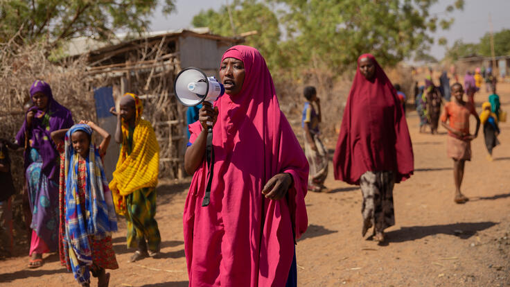 Women walking to raise awareness about women's rights.