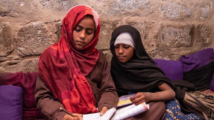 Ten-year-old Aisha studying with her best friend Na'aem.