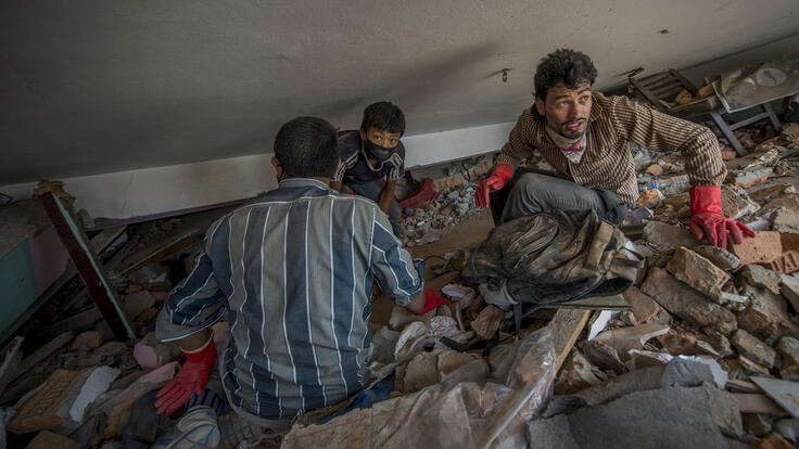 People searching through debris for their belongings.