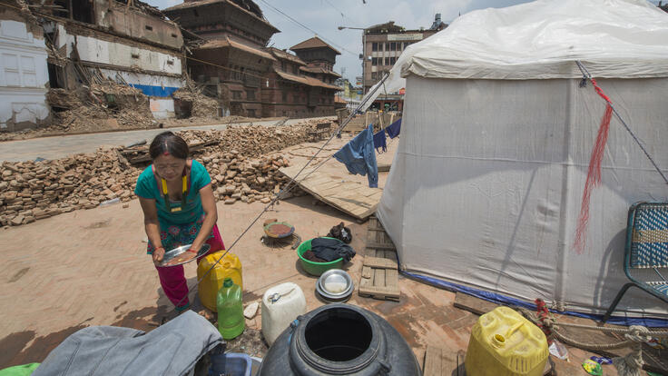 A person setting up camp.