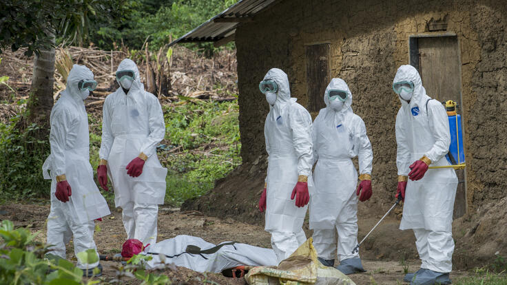 A burial team about to carry away the body of a man suspected of having died from Ebola.
