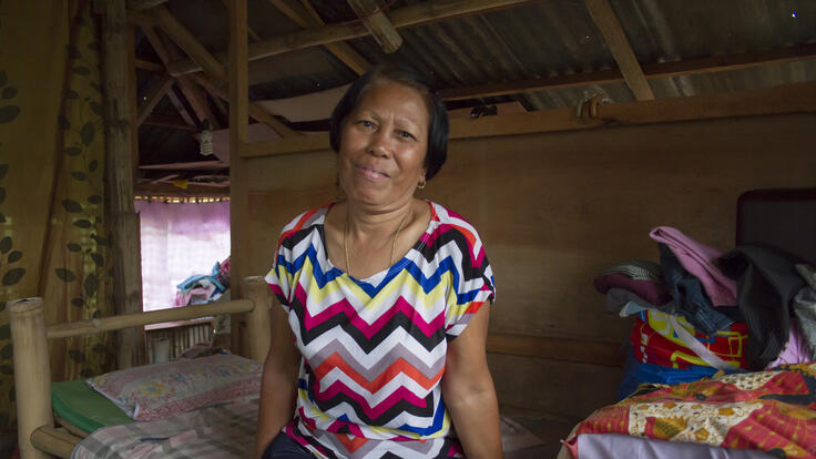 Azuelo sitting inside of her rebuilt home.