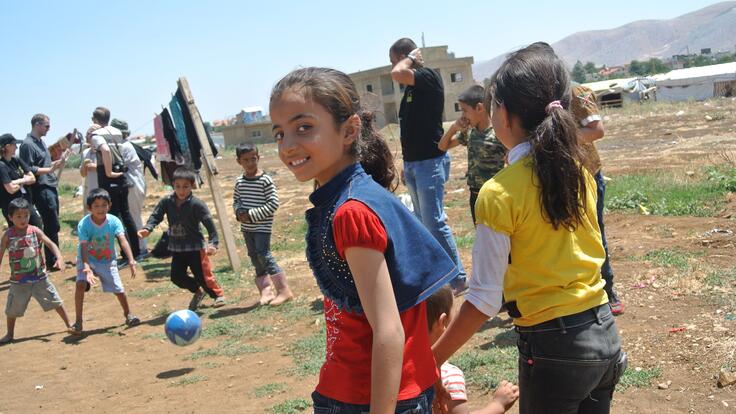 A group of children playing football.