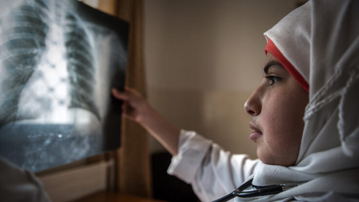 A young girl examining an x-ray.