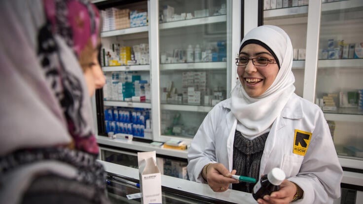 An IRC pharmacist helping a patient.