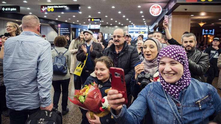 A dozen friends and neighbors welcoming the Bazara children to America.