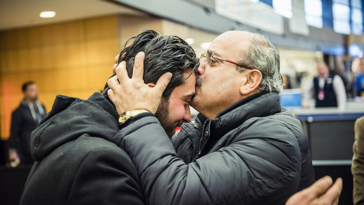 Father and son hugging.